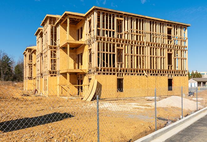 a job site enclosed by temporary chain link fences, ensuring safety for workers and pedestrians in Revere, MA